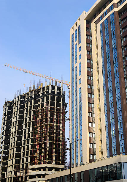istock High-rise building under construction and crane 476705862