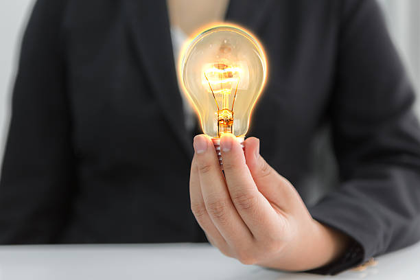 istock Business man holding light bulb 476709434