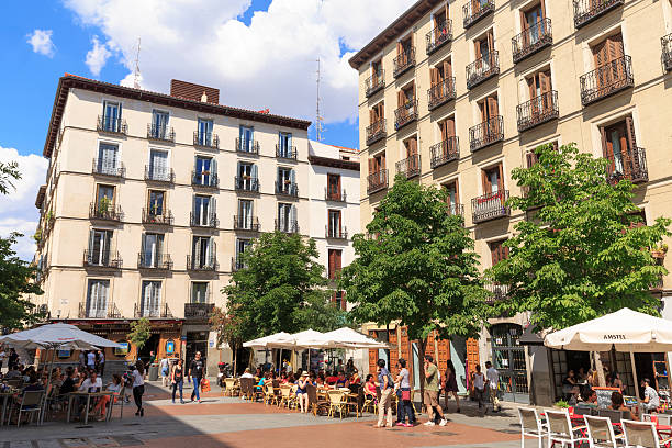 Madrid, Spain - May 31, 2015: People frequenting the bars in plaza Chueca in Madrid, Spain. Chueca is a barrio in the centre of Madrid, famous  for its bars, cafes, nightlife and gay scene. 