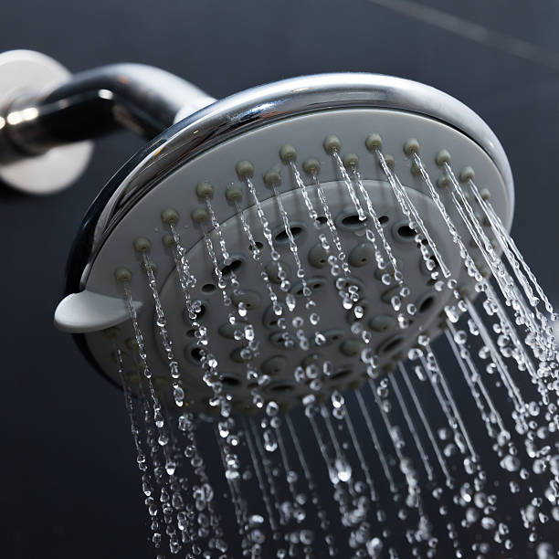 istock shower head in bathroom with water drops flowing 476710606