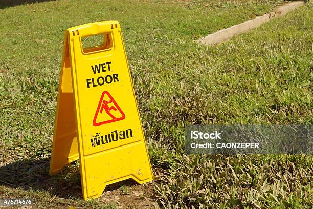 Yellow Sign Warning For Wet Floor At The Park Stock Photo - Download Image Now - 2015, Danger, Flooring