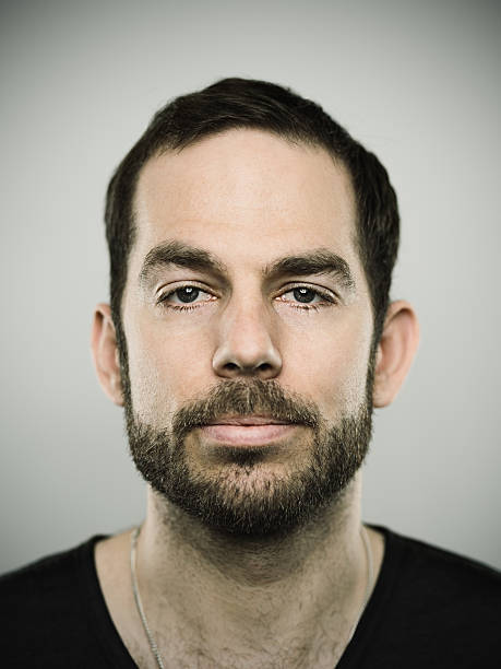 Portrait of a caucasian real man Portrait of a real caucasian man with neutral expression. Short hair, brown eyes and muscular complexion. 30 years old swiss. Vertical color image from a dslr camera in studio. istockalypse stock pictures, royalty-free photos & images