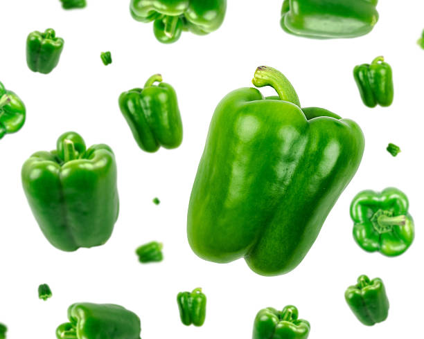 Green bell pepper falling from the sky stock photo