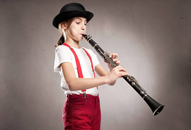 istock little girl playing clarinet 476721649