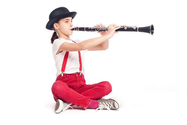 istock little girl playing clarinet 476722123