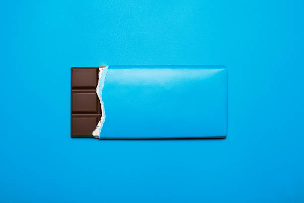 Chocolate bar Bar of chocolate on a blue background chocolate bar stock pictures, royalty-free photos & images