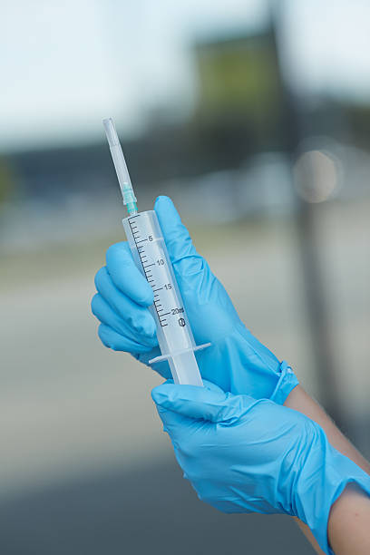 istock female doctor holding a syringe 476725100