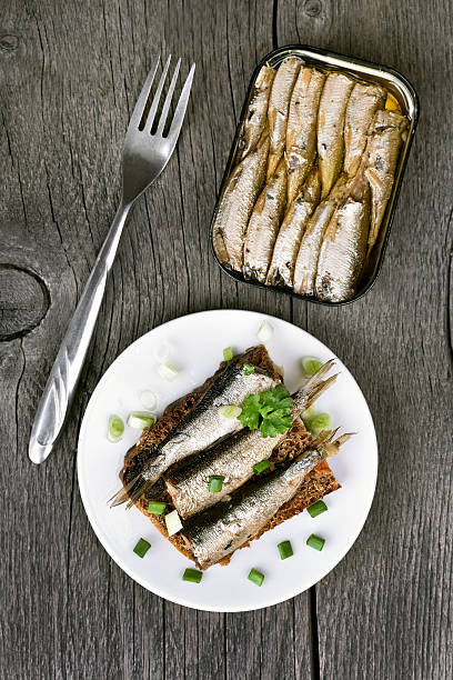 Sprats sandwich, top view Sprats sandwich on wooden table, top view kipper stock pictures, royalty-free photos & images