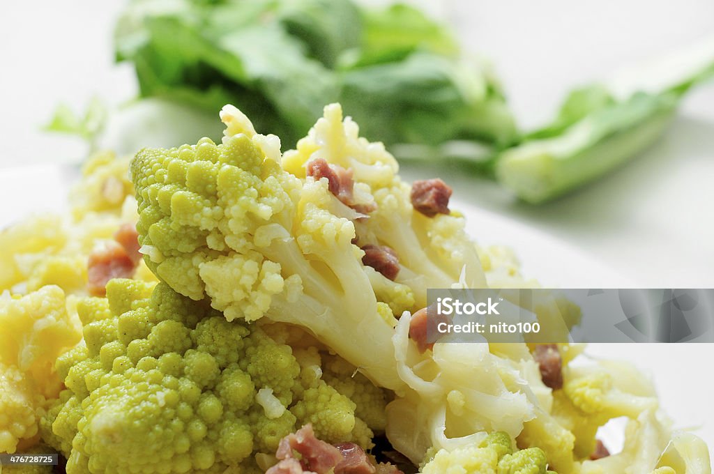 sauteed romanesco broccoli with bacon closeup of a plate with sauteed romanesco broccoli with bacon Broccoli Stock Photo