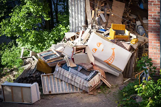 Funny broken furnitures trash pile at yard