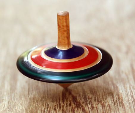 Decorative top spinning on wooden surface