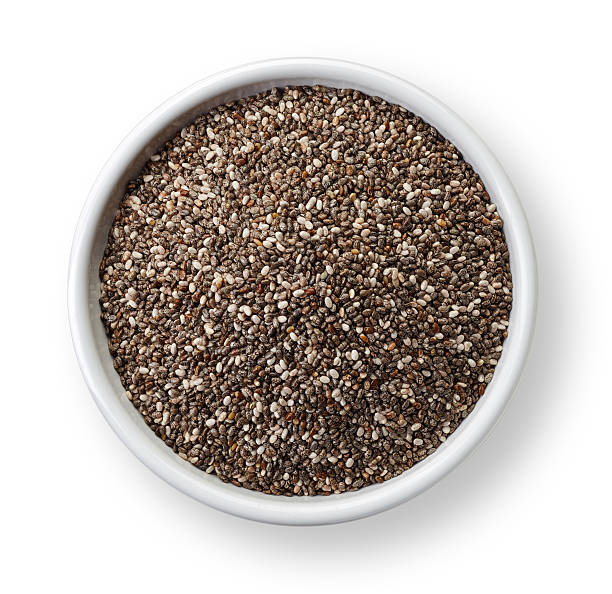 Chia seeds White bowl of chia seeds isolated on white background chia seed photos stock pictures, royalty-free photos & images