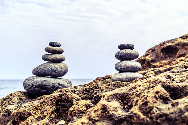 Stones balance and wellness retro spa concept, inspiration, zen-like and well being tranquil composition. Close-up of white pebbles stack over blue sea