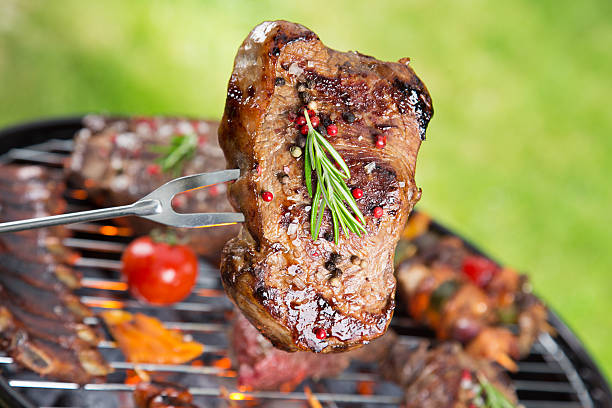 Delicious beef steak on garden grill, close-up