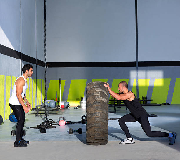 istock gym flip tires men flipping each other 476731133
