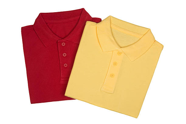 два сложенный красные и желтые рубашки-поло изолирован на белом - shirt polo shirt red collar стоковые фото и изображения