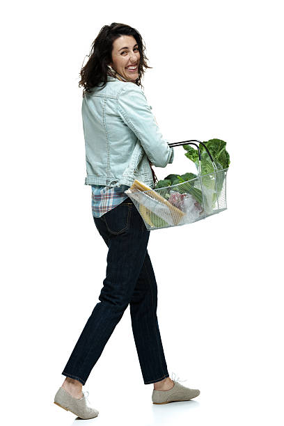 istock Woman walking with vegetable basket 476736066