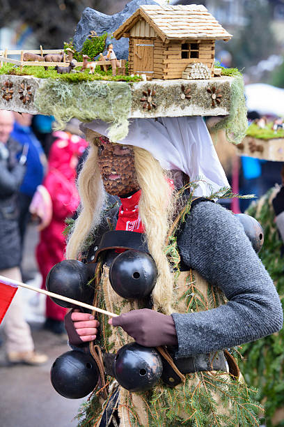 Carnival parade in Germany with spectacularly beautiful costums Bad Hindelang, Germany - Februar 15, 2015: Unknown person participates at the annual public carnival parade through the streets of city Bad Hindelang in southern part of Bavaria. The actor is dressed with hand made cothes and an creative styled hat on his head. mardi gras body painting stock pictures, royalty-free photos & images