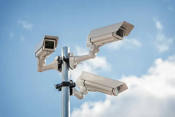 Security cctv surveillance camera in front of blue sky concept for counter-terrorism, antiterrorism and protection from crime