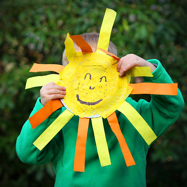 istock Child Holding Smiley Face or Happy Yellow Sun 476740244