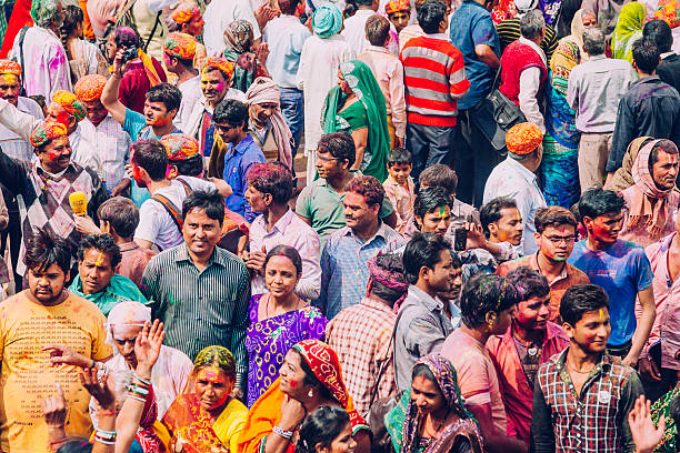 Holi Celebration in India Holi Celebration in Mathura Temple, India. india crowd stock pictures, royalty-free photos & images