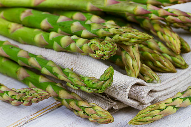 istock Asparagus on wooden background 476751604