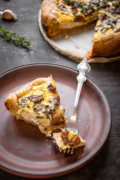 istock Caramelized garlic tart with goat cheese on dark wooden backgrou 476753068
