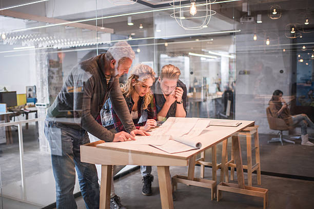 istock Architects working together on blueprints in the office. 476753098