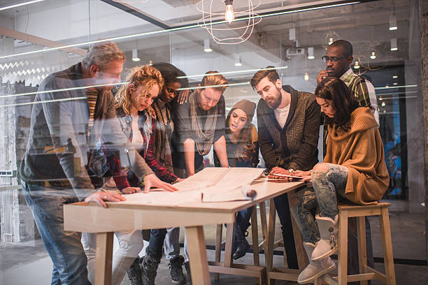 istock Large group of creative people working on blueprints. 476753120