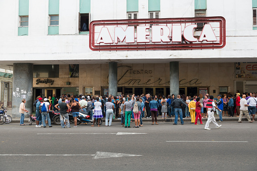 Havana, Cuba - December 17, 2014: People wait for tickets outside the Teatro America on Avenida de Galiano in Havana, Cuba
