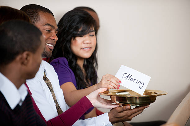 Tithe and Offering People giving tithes and offerings in church black female gospel singers stock pictures, royalty-free photos & images
