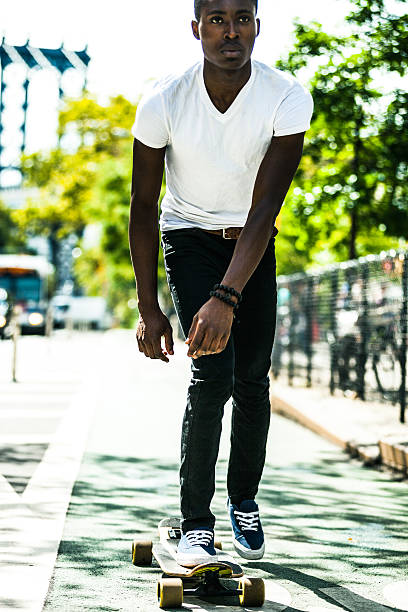 istock Young man riding on longboard in New York streets 476758956