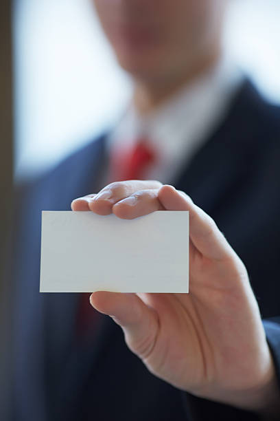 istock businessman giving a business card 476761888