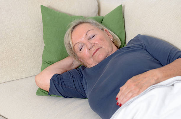 istock Close up Middle Aged Blond Woman Resting on Couch 476764352