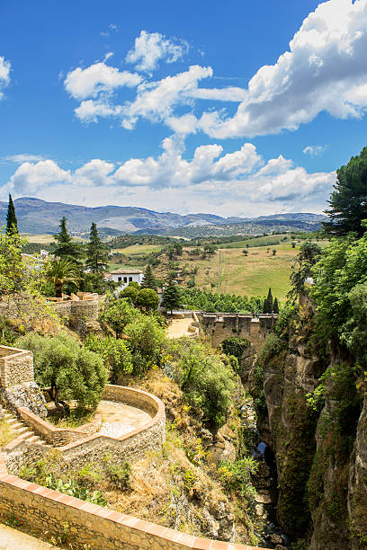 Ronda, view over Puente Viejo, old bridge. Spain Puente Viejo, Old Bridge, also known as Arab Bridge. The oldest and smallest of three bridges that span the 120-metre deep chasm that carries the GuadalevÃ­n River and divides the city of Ronda in southern Spain. It was built in 1616. madieval stock pictures, royalty-free photos & images