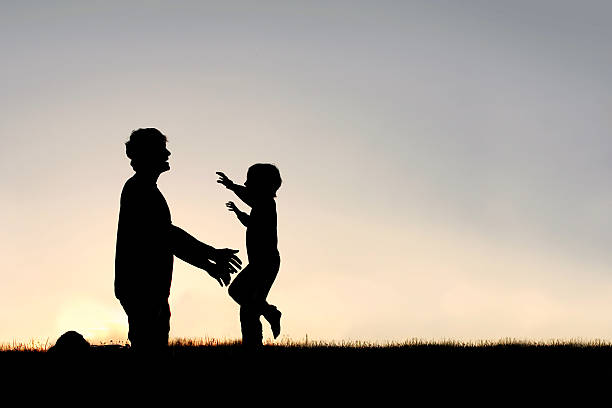 istock Happy Young Child Running to Greet Dad Silhouette 476767834