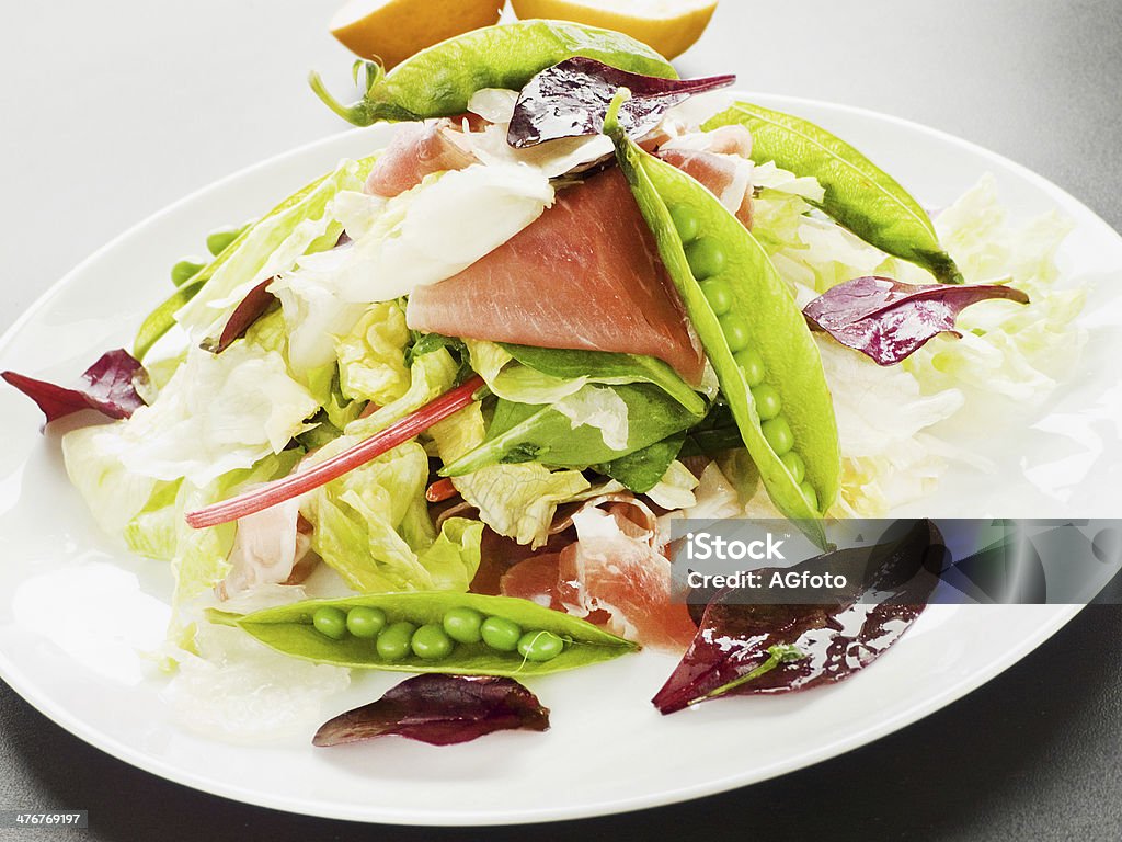 Salad Salad with prosciutto, iceberg cabbage and green peas. Shallow dof. Green Pea Stock Photo