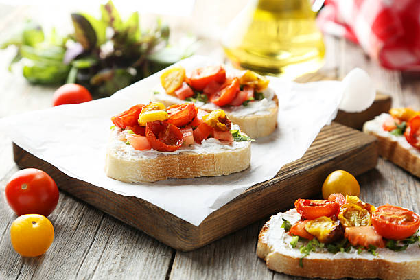 istock Tasty fresh bruschetta with tomatoes on cutting board 476771688