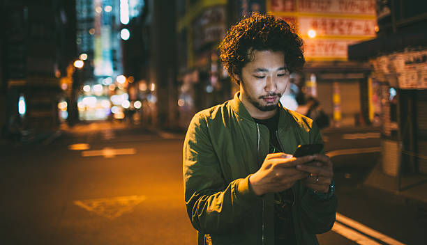 istock Young japanese man texting on the phone 476773312