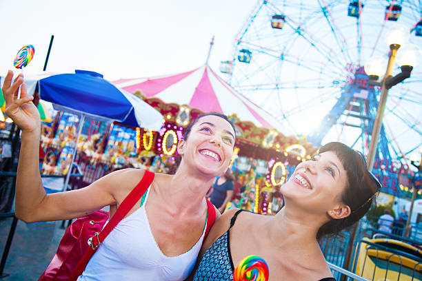istock Two friends at amusement park 476773362