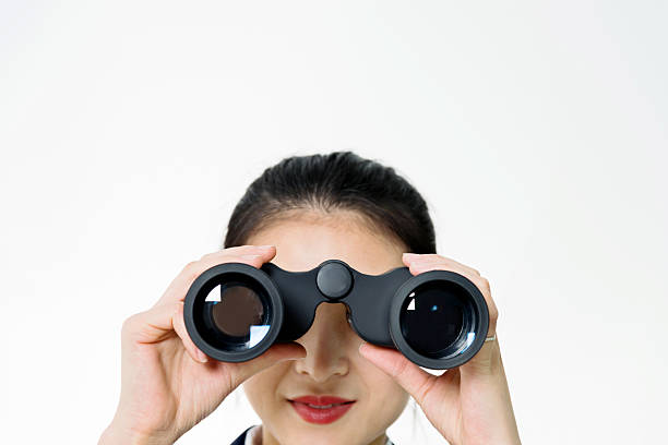 istock Businesswoman holding binoculars 476777358