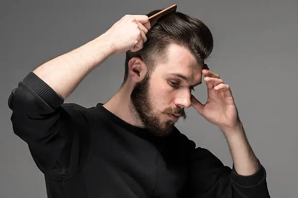 Photo of young man comb his hair