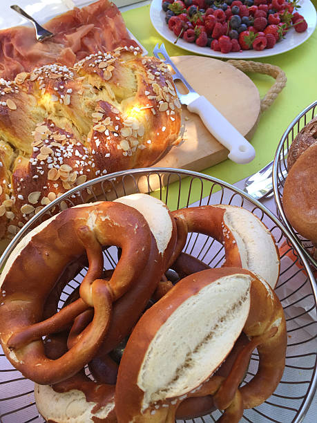 istock Brunch table with pretzels, fruits, ham, Hefezopf and bread 476780322