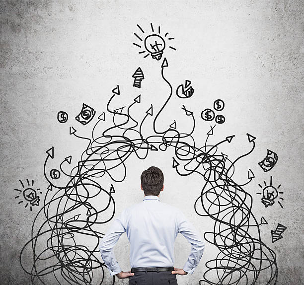 istock businessman looking at arrows 476787354