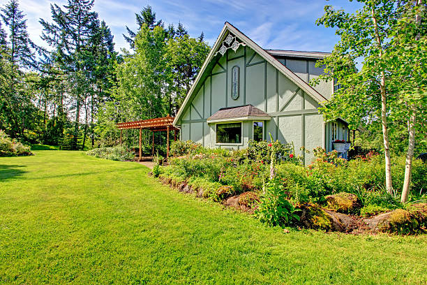 istock Big farmhouse with beautiful flowerbed 476787869