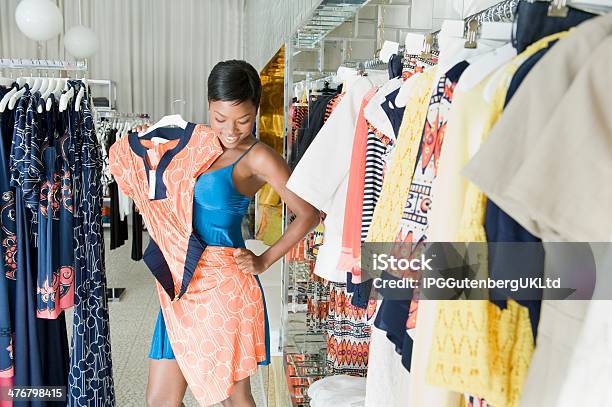 African American Female Choosing Dress At Clothing Store Stock Photo - Download Image Now