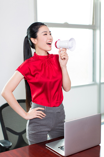 asian female white-collar workers in the office to take the speaker