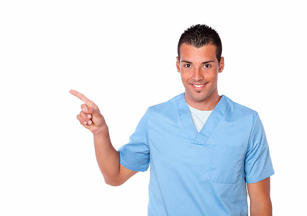 istock Charismatic nurse guy pointing to his right 476802675