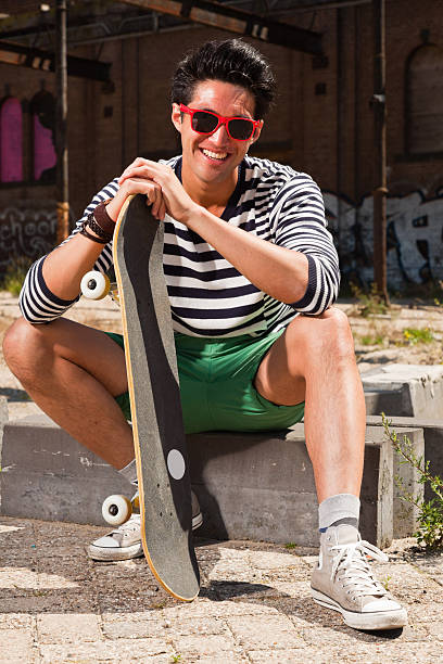 istock Urban asian man with red sunglasses and skateboard. 476802889
