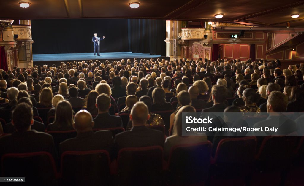 Audience watching performer on stage in theater  Stage Theater Stock Photo